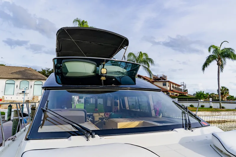 Nauti Obsession Yacht Photos Pics 2015 Monte Carlo MC5 yacht docked, featuring sleek design and spacious interior.