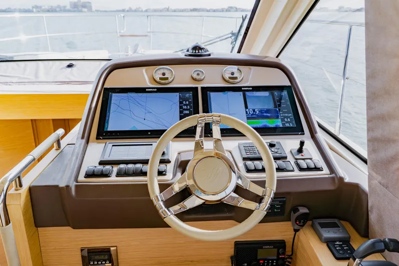 Nauti Obsession Yacht Photos Pics Steering console of 2015 Monte Carlo MC5 yacht with navigation screens and controls.