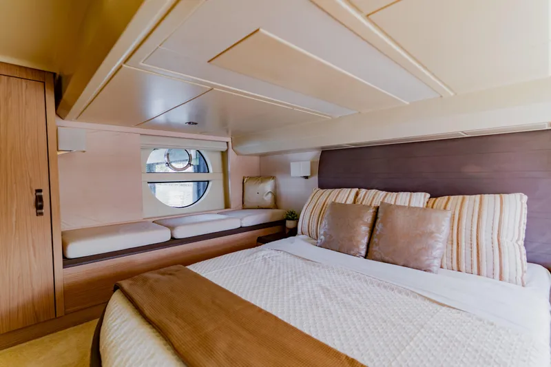 Nauti Obsession Yacht Photos Pics Luxurious 2015 Monte Carlo MC5 yacht bedroom with elegant decor and round window.