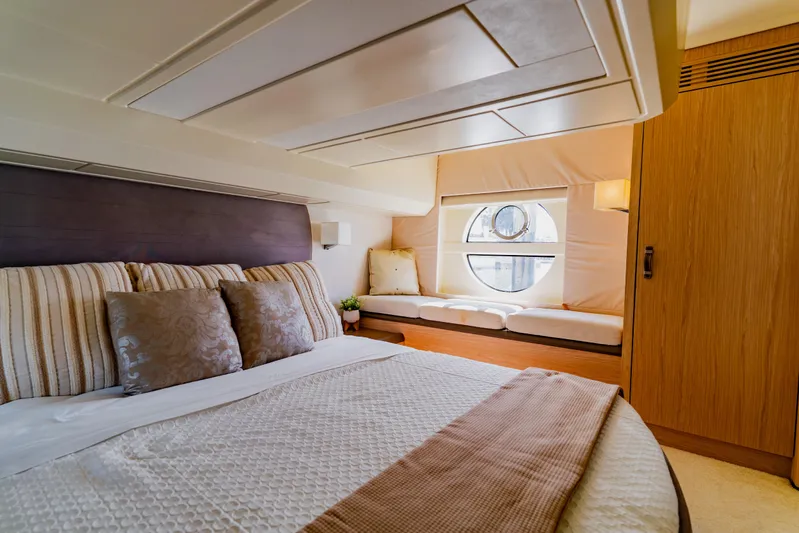 Nauti Obsession Yacht Photos Pics Luxurious 2015 Monte Carlo MC5 yacht bedroom with elegant decor and circular window.