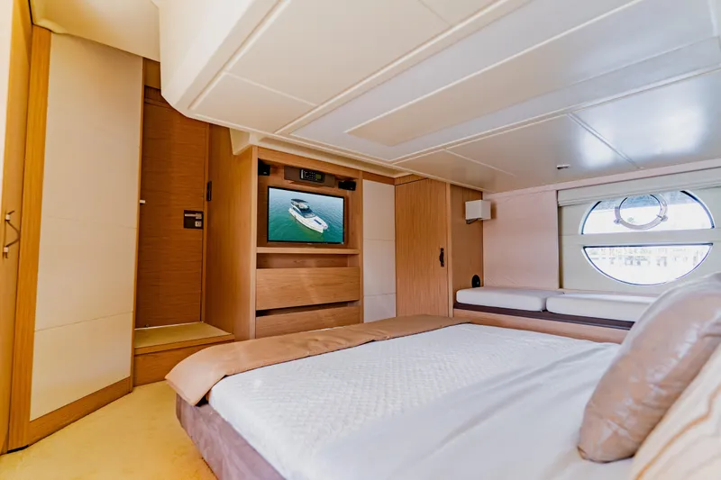 Nauti Obsession Yacht Photos Pics Luxurious 2015 Monte Carlo MC5 yacht bedroom with modern decor and circular window.