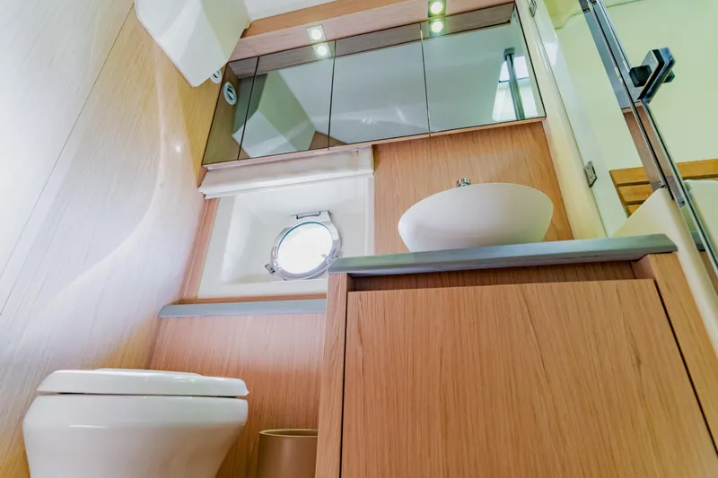 Nauti Obsession Yacht Photos Pics Luxurious bathroom in 2015 Monte Carlo MC5 yacht with modern fixtures and wooden cabinetry.