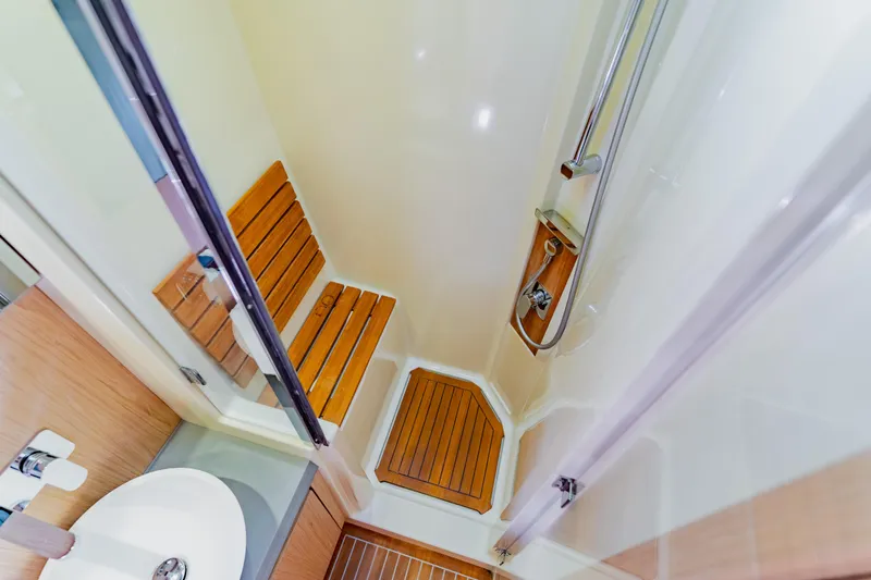 Nauti Obsession Yacht Photos Pics Luxurious shower area in 2015 Monte Carlo MC5 yacht with wooden seating and modern fixtures.