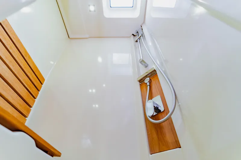 Nauti Obsession Yacht Photos Pics Luxurious shower area in 2015 Monte Carlo MC5 yacht with wooden accents and modern fixtures.
