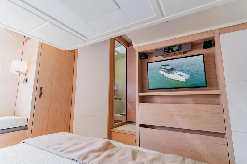 Nauti Obsession Yacht Photos Pics Luxurious Monte Carlo MC5 2015 yacht interior with TV and modern wood finish.