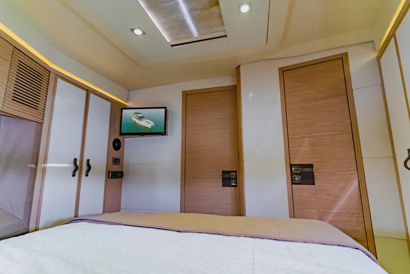 Nauti Obsession Yacht Photos Pics Luxurious interior of 2015 Monte Carlo MC5 yacht cabin with modern design and TV.