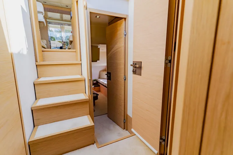 Nauti Obsession Yacht Photos Pics Interior of 2015 Monte Carlo MC5 yacht, featuring wooden stairs and modern design.