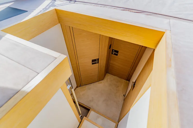 Nauti Obsession Yacht Photos Pics Staircase leading to wooden doors inside 2015 Monte Carlo MC5 yacht.