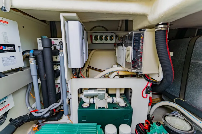 Nauti Obsession Yacht Photos Pics Engine room of 2015 Monte Carlo MC5 yacht, showcasing complex mechanical systems and wiring.