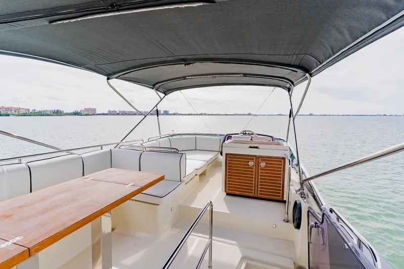 Nauti Obsession Yacht Photos Pics Luxurious 2015 Monte Carlo MC5 yacht interior with seating and table on open water.