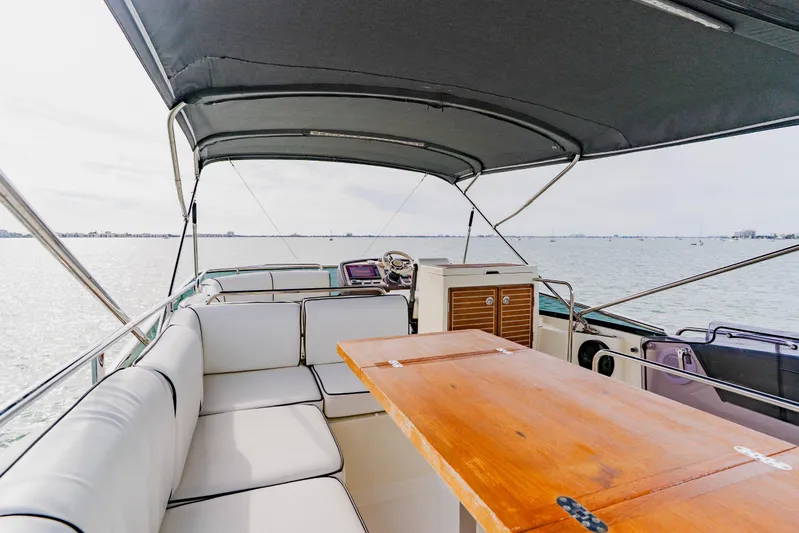 Nauti Obsession Yacht Photos Pics Luxury Monte Carlo MC5 yacht interior with seating and table, 2015 model, on open water.