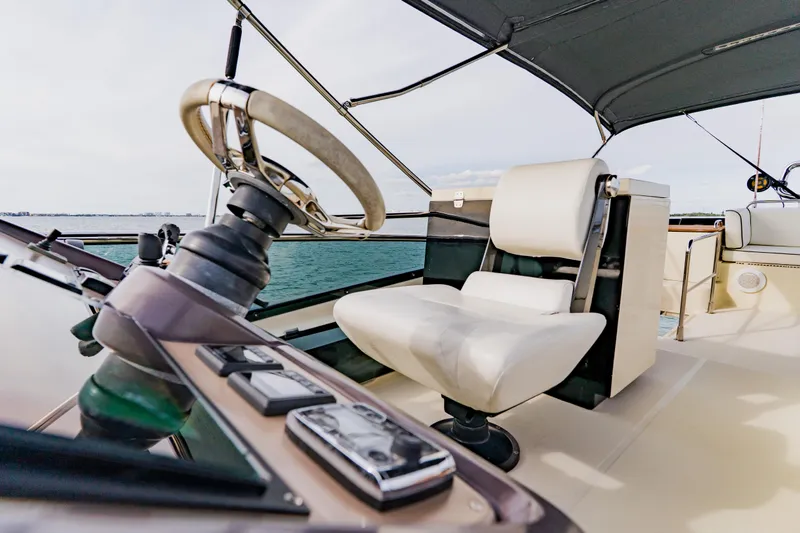 Nauti Obsession Yacht Photos Pics Helm of 2015 Monte Carlo MC5 yacht with steering wheel and captain's chair.