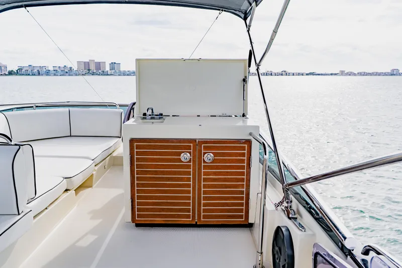 Nauti Obsession Yacht Photos Pics Luxury Monte Carlo MC5 yacht interior with seating and kitchenette, 2015 model, on open water.