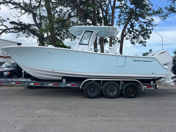  Yacht Photos Pics 2025 Sportsman Open 262 Center Console boat on a trailer, parked outdoors.