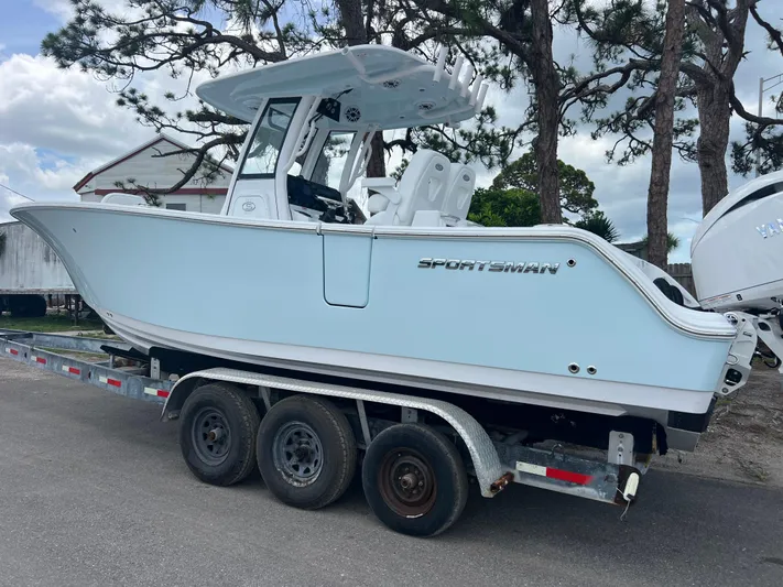  Yacht Photos Pics 2025 Sportsman Open 262 Center Console boat on trailer, parked outdoors.
