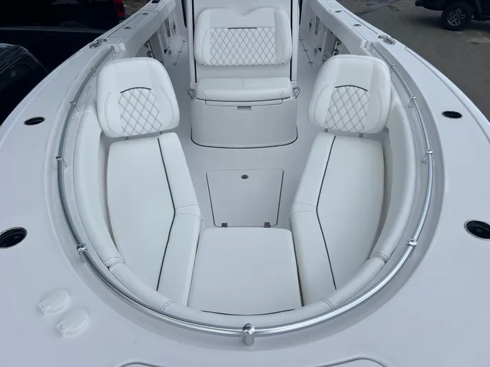  Yacht Photos Pics 2025 Sportsman Open 262 Center Console boat with luxurious white seating and stainless steel railings.