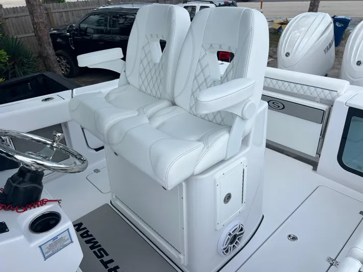  Yacht Photos Pics 2025 Sportsman Open 262 Center Console with white cushioned seating and steering wheel.