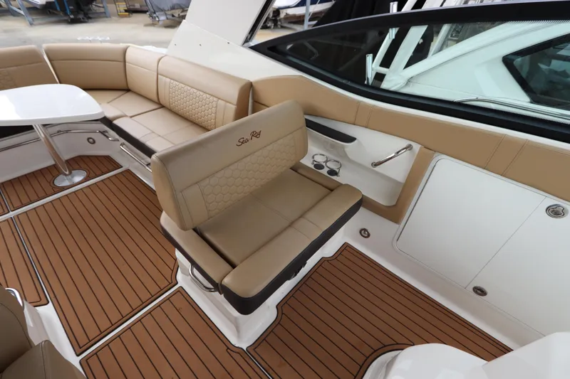  Yacht Photos Pics 2019 Sea Ray Sundancer 320 interior with tan seating and wood-style flooring.