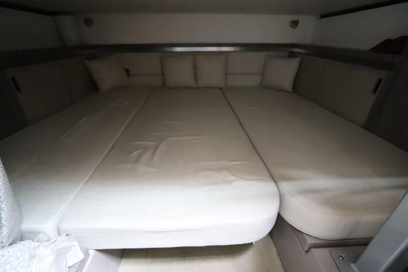  Yacht Photos Pics Interior cabin of 2019 Sea Ray Sundancer 320 with beige cushions and bedding.