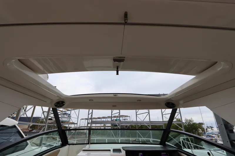  Yacht Photos Pics 2019 Sea Ray Sundancer 320 boat interior with open sunroof, docked at marina.