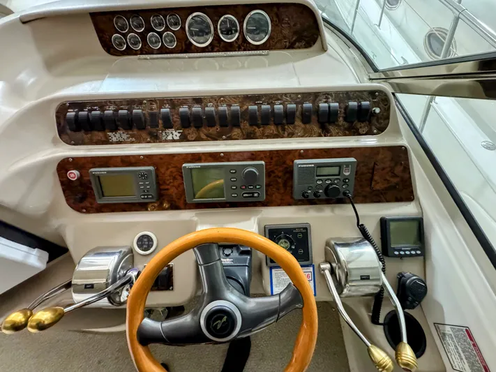 Lady Barb Yacht Photos Pics 1998 Sea Ray 400 Sundancer dashboard with wood paneling and instruments.