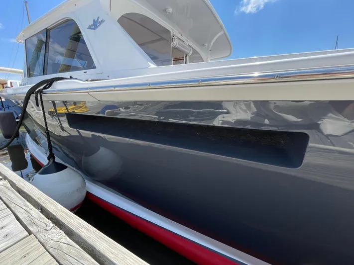 Bushwacker Yacht Photos Pics 1972 Bertram 31 Sedan Hardtop Cruiser docked, showcasing sleek design and classic style.
