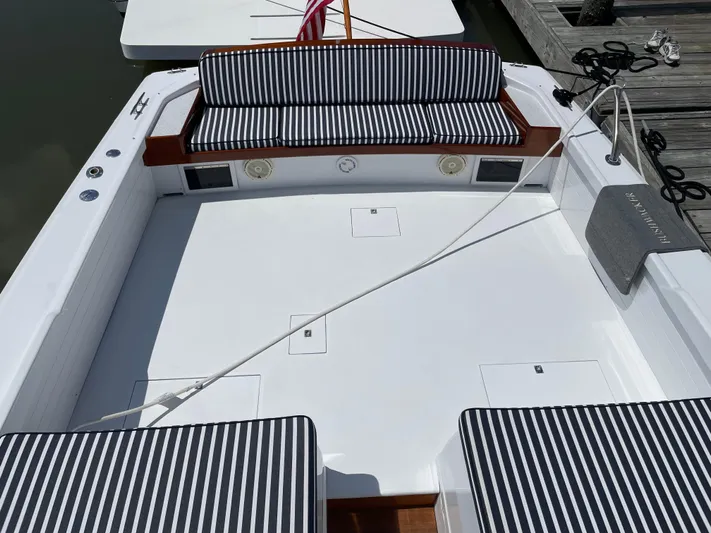 Bushwacker Yacht Photos Pics 1972 Bertram 31 Sedan Hardtop Cruiser with striped seating, docked at marina.