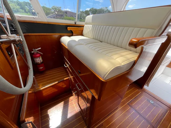 Bushwacker Yacht Photos Pics Interior of 1972 Bertram 31 Sedan Hardtop Cruiser with wooden flooring and cushioned seating.