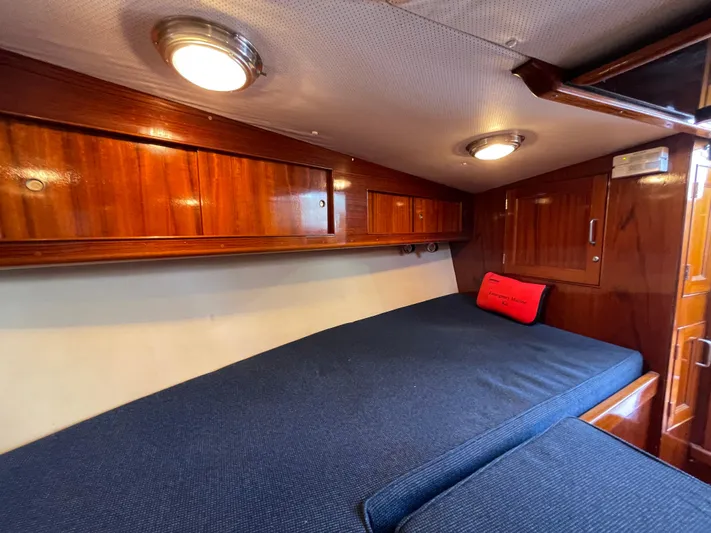 Bushwacker Yacht Photos Pics Interior cabin of 1972 Bertram 31 Sedan Hardtop Cruiser with wood paneling and blue bedding.