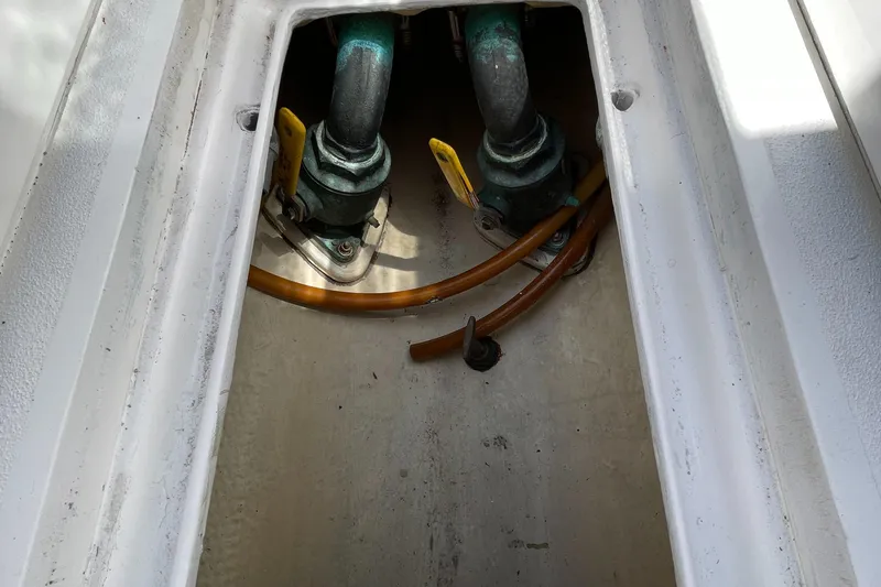 Bushwacker Yacht Photos Pics Engine compartment of 1972 Bertram 31 Sedan Hardtop Cruiser with visible hoses and fittings.