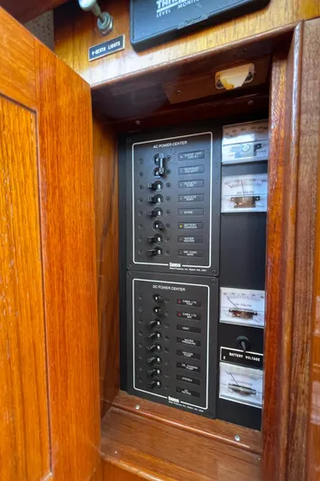 Bushwacker Yacht Photos Pics Electrical panel inside 1972 Bertram 31 Sedan Hardtop Cruiser with wooden cabinet.