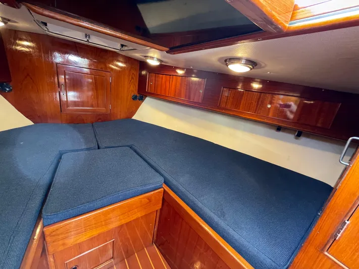 Bushwacker Yacht Photos Pics Interior cabin of 1972 Bertram 31 Sedan Hardtop Cruiser with wood paneling and blue cushions.