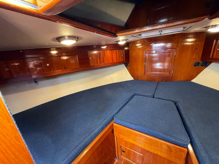 Bushwacker Yacht Photos Pics Interior of 1972 Bertram 31 Sedan Hardtop Cruiser with wood paneling and blue cushions.
