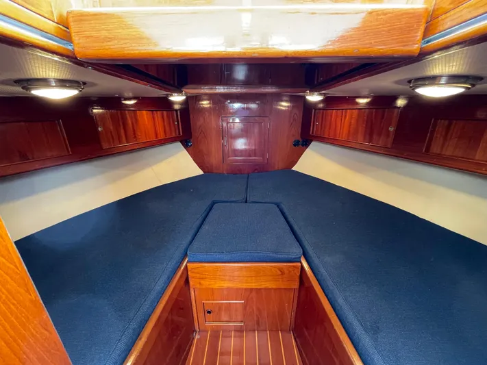 Bushwacker Yacht Photos Pics Interior of 1972 Bertram 31 Sedan Hardtop Cruiser with wood finish and blue cushions.