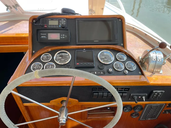 Bushwacker Yacht Photos Pics 1972 Bertram 31 Sedan Hardtop Cruiser dashboard with steering wheel and navigation instruments.