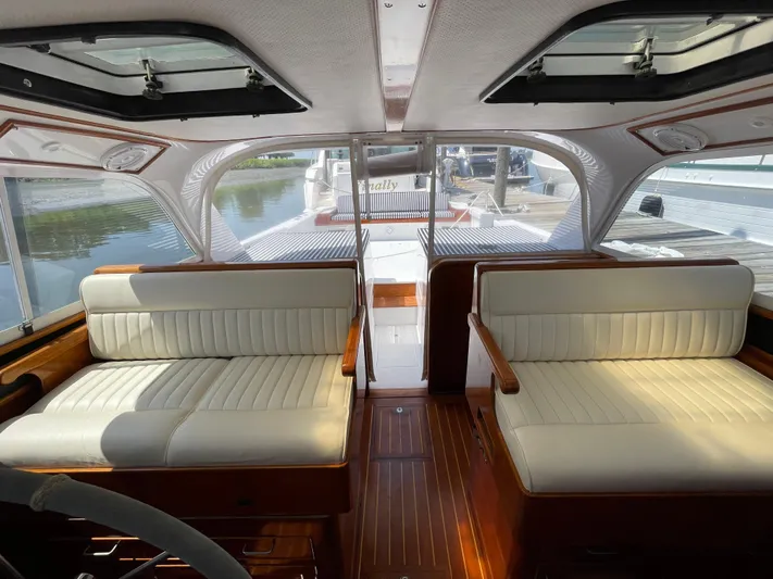 Bushwacker Yacht Photos Pics Interior of a 1972 Bertram 31 Sedan Hardtop Cruiser with white seating and wood accents.