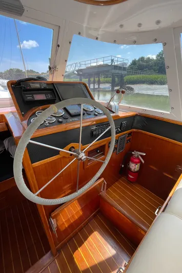 Bushwacker Yacht Photos Pics Interior of a 1972 Bertram 31 Sedan Hardtop Cruiser with wooden steering wheel.