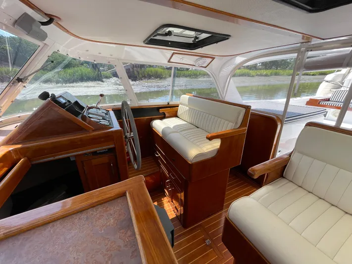 Bushwacker Yacht Photos Pics Interior of a 1972 Bertram 31 Sedan Hardtop Cruiser with wood and white upholstery.