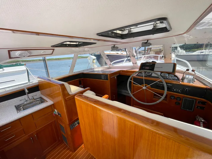 Bushwacker Yacht Photos Pics Interior of a 1972 Bertram 31 Sedan Hardtop Cruiser with wooden finishes and steering wheel.