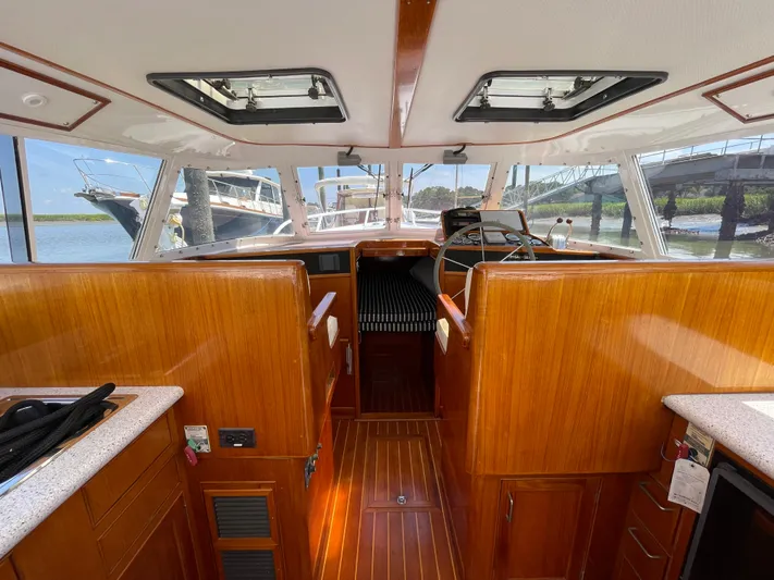 Bushwacker Yacht Photos Pics Interior of 1972 Bertram 31 Sedan Hardtop Cruiser with wooden finishes and helm view.