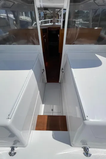 Bushwacker Yacht Photos Pics 1972 Bertram 31 Sedan Hardtop Cruiser interior with white seating and wood accents.