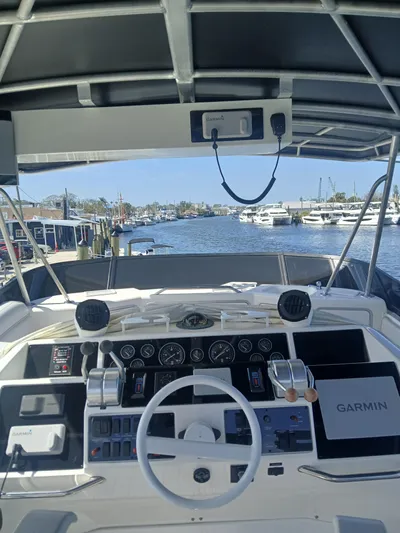  Yacht Photos Pics 1997 Sea Ray 550 Sedan Bridge helm with Garmin navigation, docked at marina.