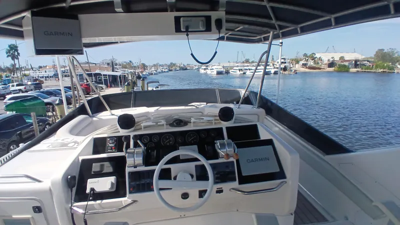  Yacht Photos Pics 1997 Sea Ray 550 Sedan Bridge helm with Garmin navigation, overlooking marina and waterfront.