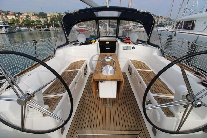 A Yacht Photos Pics 2009 Dufour 425 Grand Large yacht cockpit with dual steering wheels and teak flooring.