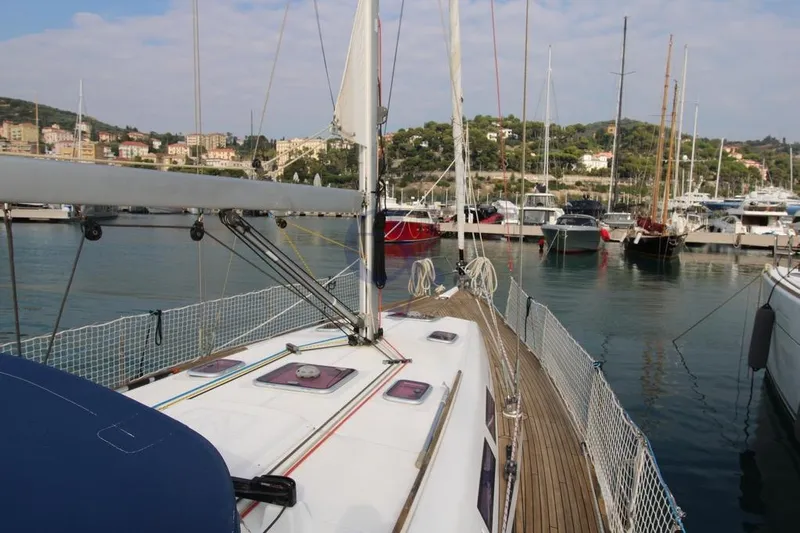 A Yacht Photos Pics 2009 Dufour 425 Grand Large sailboat docked in a scenic marina.