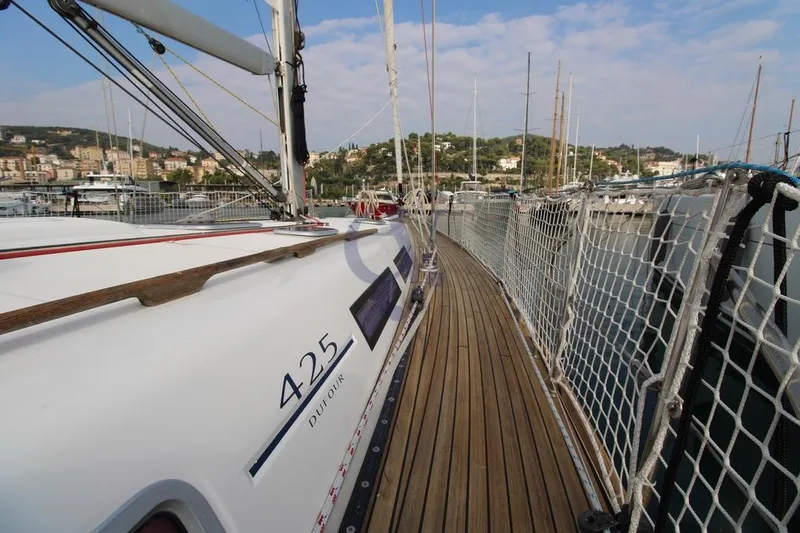 A Yacht Photos Pics 2009 Dufour 425 Grand Large sailboat docked in a scenic marina.