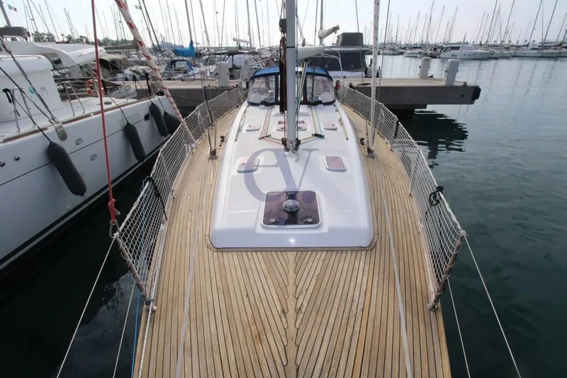 A Yacht Photos Pics 2009 Dufour 425 Grand Large sailboat docked in a marina, showcasing teak deck.