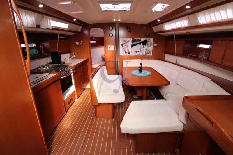 A Yacht Photos Pics Interior of 2009 Dufour 425 Grand Large yacht with wooden finish and cozy seating.