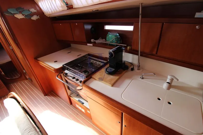 A Yacht Photos Pics 2009 Dufour 425 Grand Large yacht kitchen with stove, sink, and coffee maker.