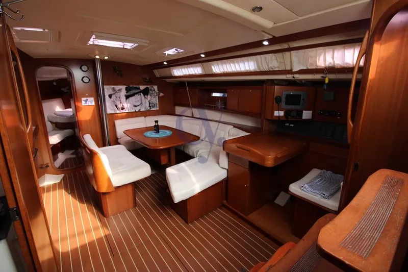 A Yacht Photos Pics Interior of 2009 Dufour 425 Grand Large yacht with elegant wood finish and seating area.